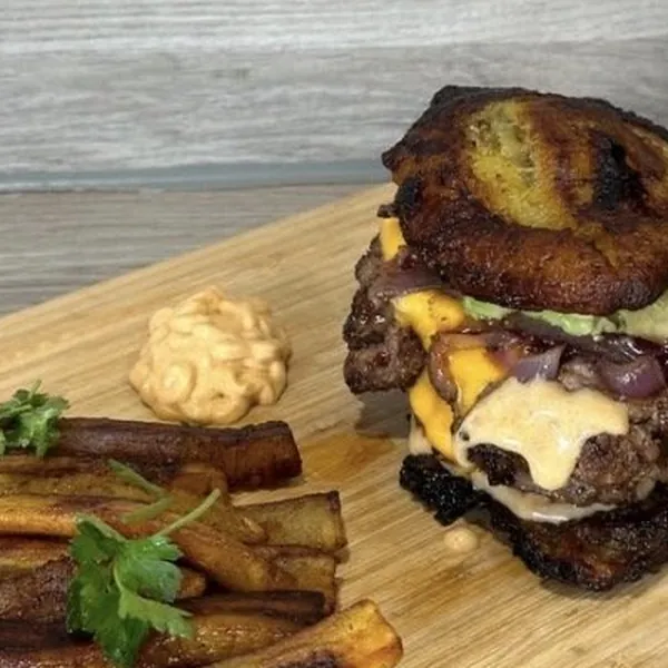 Smashed burger with plantain on a board