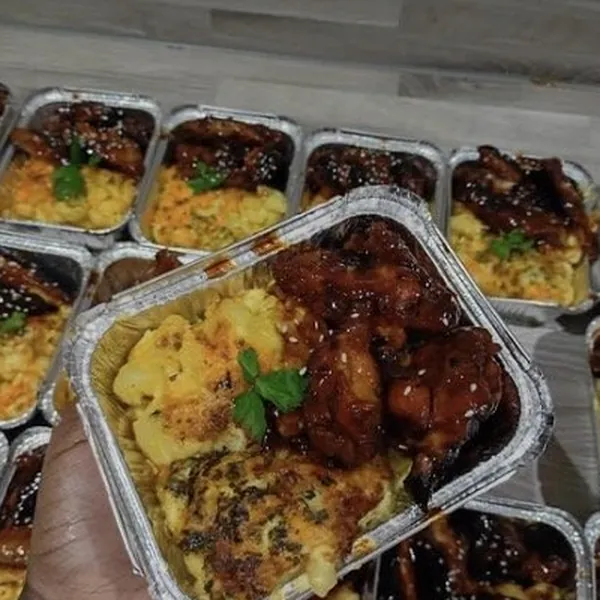 Foil trays of wings and mac and cheese