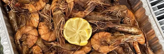 A tray of king prawns with lemon