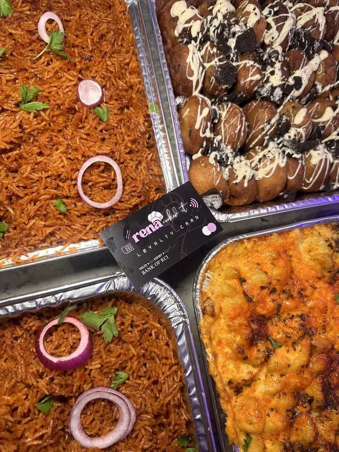 Foil trays of jollof rice and mac and cheese