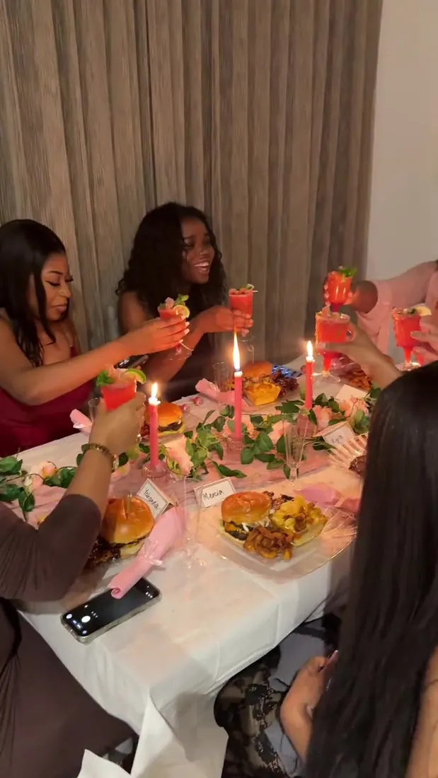 Guests raising a toast at a candlelit private dinner