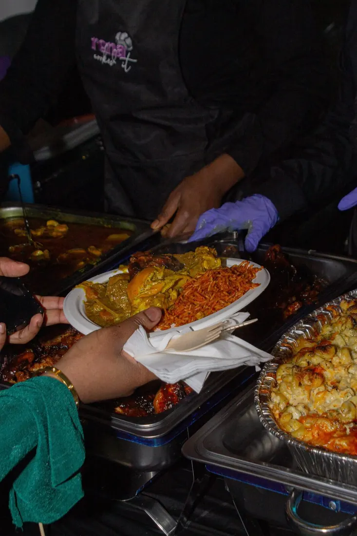 A wedding guest being served a full plate